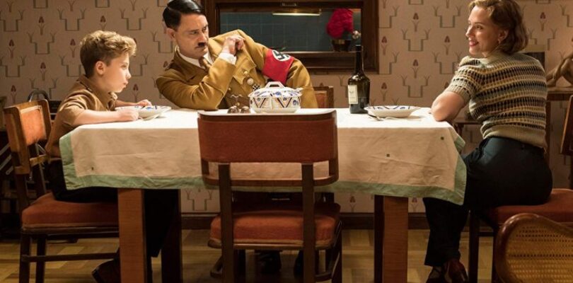 Roman Griffin Davis (left-right), Taika Waititi, and Scarlett Johansson in Jojo Rabbit.