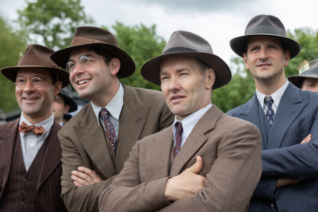 Chris Diamantopoulos (l-r) stars as Royal Brougham, James Wolk as Coach Bolles, and Joel Edgerton as Al Ulbrickson in director George Clooney’s THE BOYS IN THE BOAT. Chris Diamantopoulos (l-r) stars as Royal Brougham, James Wolk as Coach Bolles, and Joel Edgerton as Al Ulbrickson in director George Clooney’s THE BOYS IN THE BOAT.
